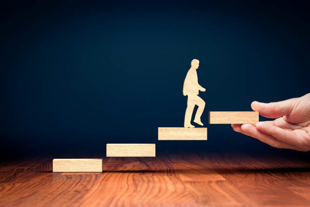 Paper cutout of person walking up wooden steps