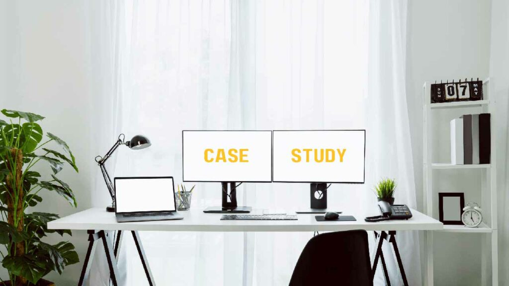 Two monitors on a desk in a study. One monitor has the word "case" and the other has the word "study" on it.