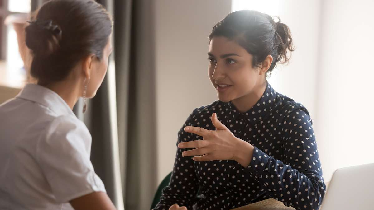 Two women having a work conversation.