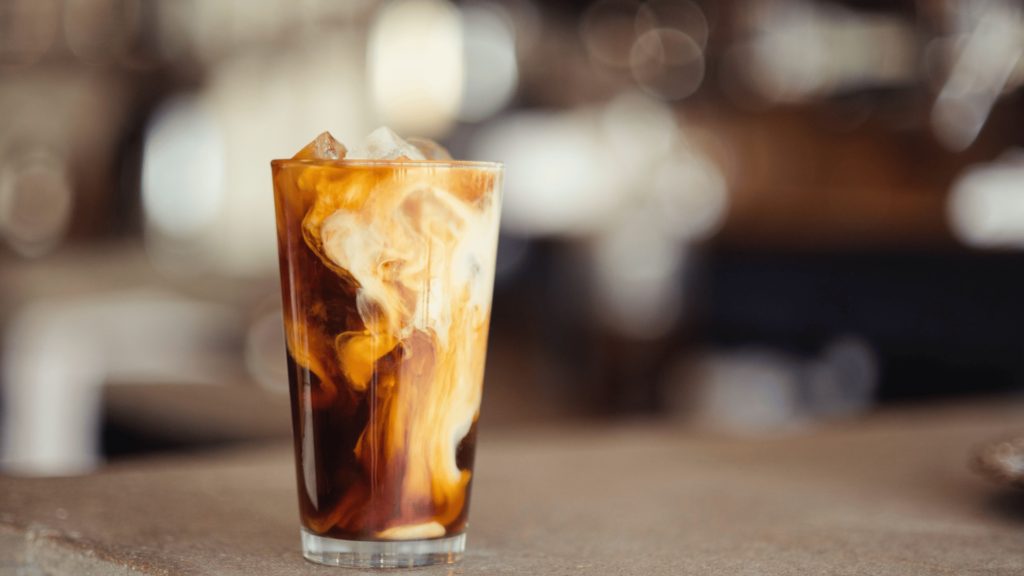 a cup of iced coffee filled with non dairy creamer