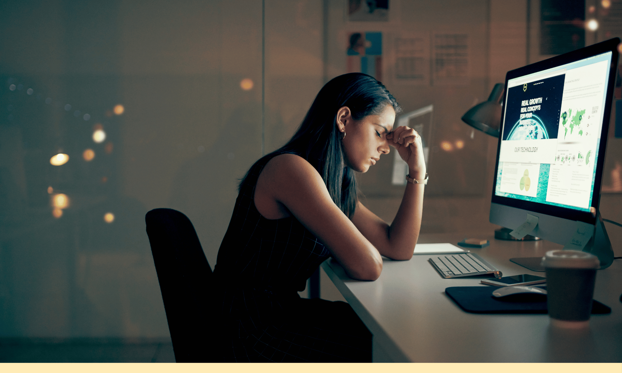 a woman sitting at a computer looking stressed
